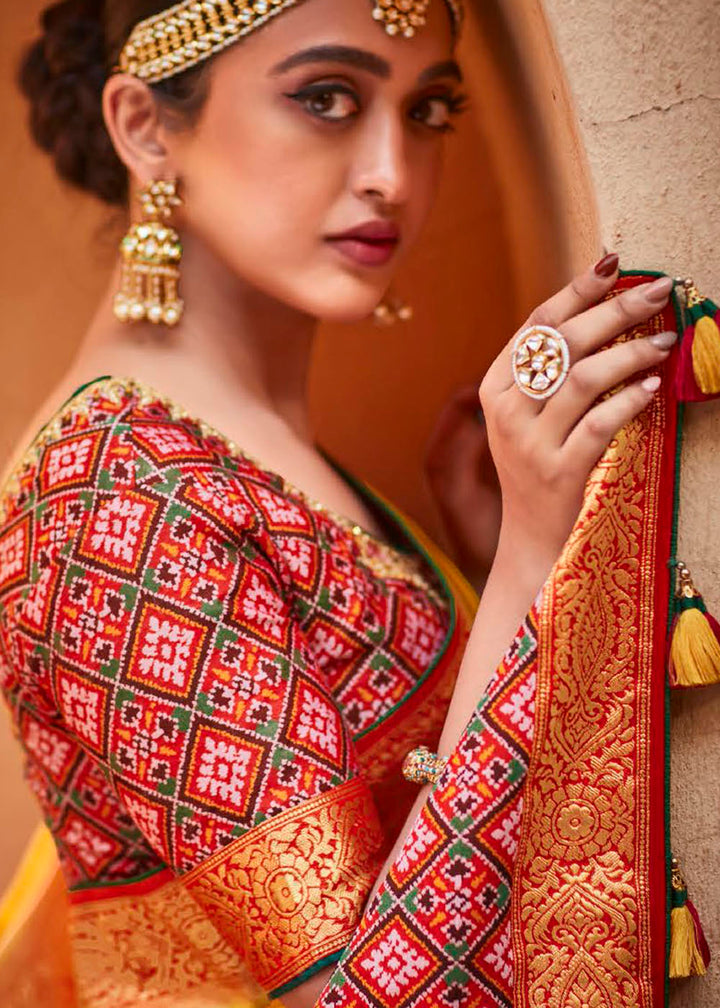 Saffron Yellow Woven Banarasi Patola Silk Saree with Embroidered Blouse