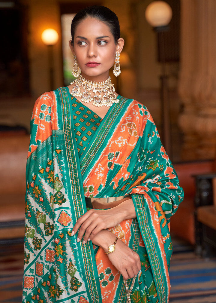 Green & Orange Printed Patola Silk Saree with Zari Border & Tassels on Pallu