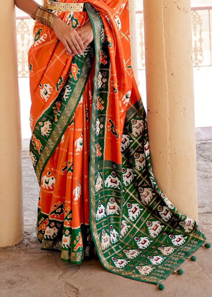 Pumpkin Orange Printed Patola Silk Saree with Zari Border & Tassels on Pallu